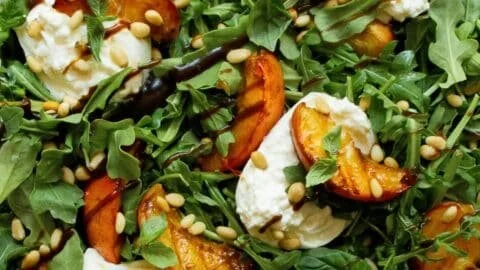 Delicious grilled peach salad with burrata and balsamic drizzle