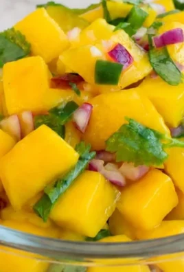 Bowl of homemade peach salsa with fresh ingredients
