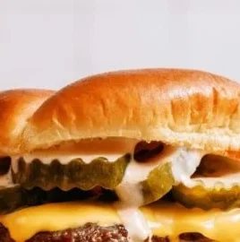 Delicious homemade smash burgers served with Shack sauce on a plate
