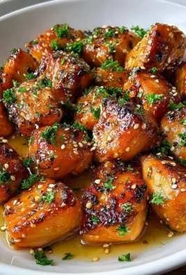 Delicious honey garlic salmon bites served on a plate with garnishes