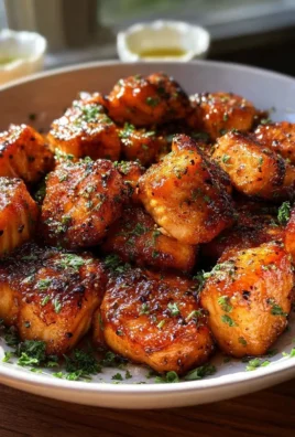 Delicious hot honey salmon bites served on a plate.