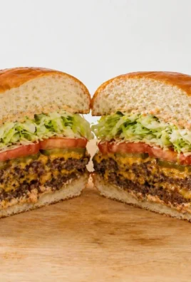 Delicious juicy smash burger with crispy crust and melted cheese on a wooden board