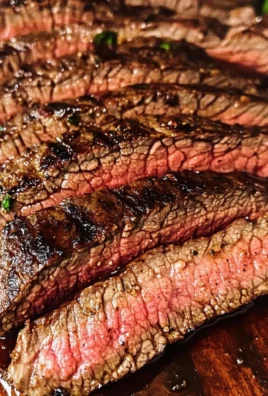 Juicy marinated grilled flank steak on a serving platter