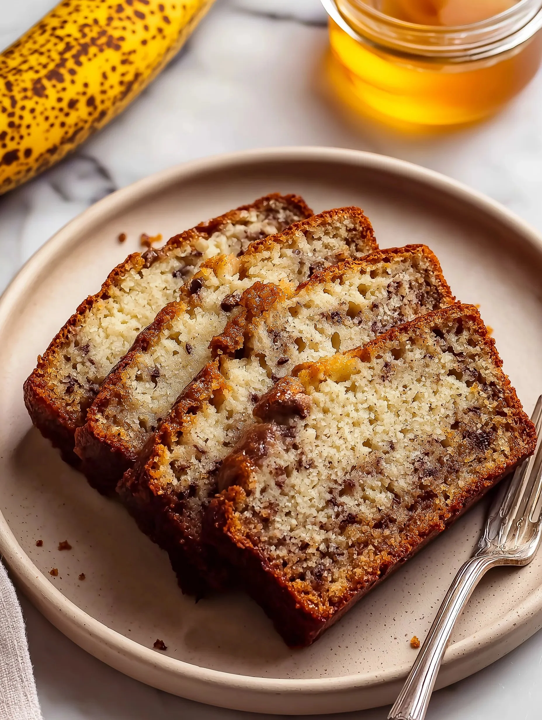 Loaf of moist cottage cheese banana bread on a wooden table