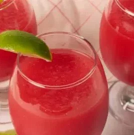 A vibrant watermelon lime slushi served in a glass, perfect for summer refreshment.