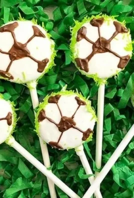 Soccer Oreo Cookie Pops decorated like soccer balls for a fun snack.