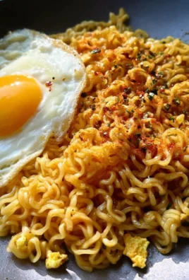 Bowl of sweet and spicy ramen noodles topped with fresh herbs and vegetables.