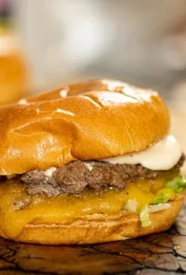 Delicious homemade smash burger on a grill with toppings