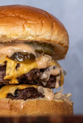 Delicious homemade smash burger with toppings on a wooden table
