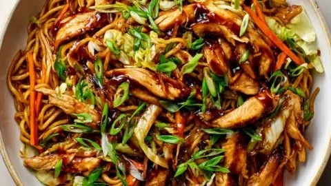 Delicious chicken chow mein with crispy pan-fried noodles and fresh vegetables.