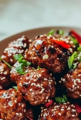 Plate of delicious Asian meatballs garnished with herbs and served with dipping sauce.