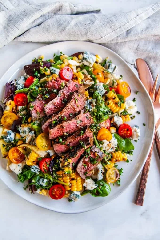 Balsamic Steak Gorgonzola Salad with grilled corn and colorful vegetables