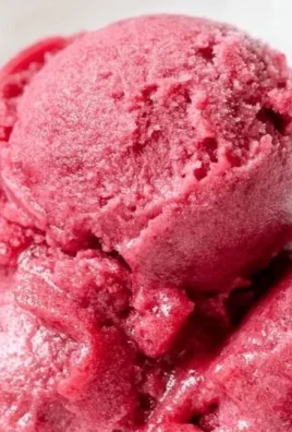Bowl of homemade cherry sorbet topped with fresh cherries