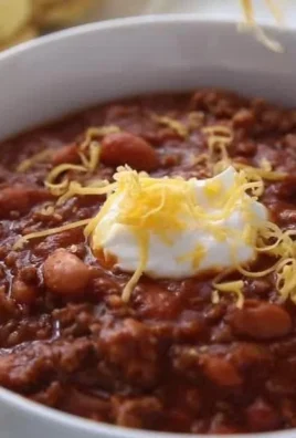 Bowl of classic homemade chili topped with cheese and cilantro