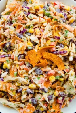 Bowl of Frito Cowboy Cabbage with colorful ingredients and crunchy Fritos