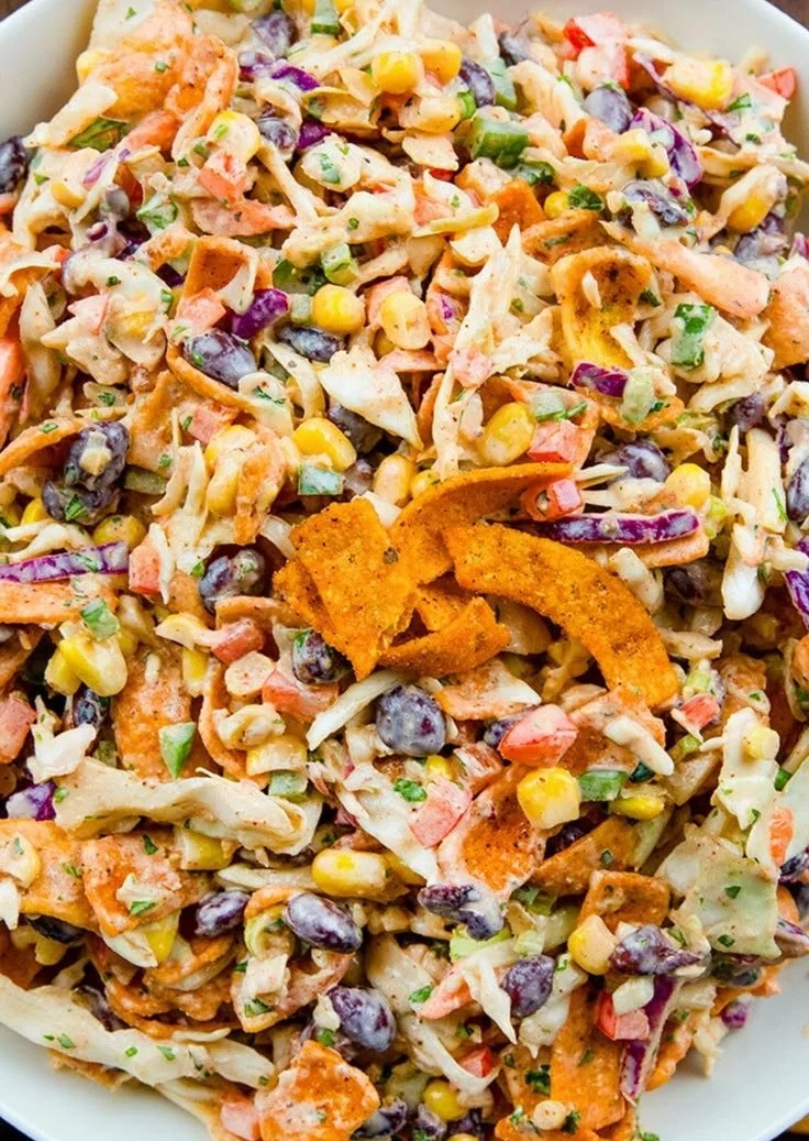 Bowl of Frito Cowboy Cabbage with colorful ingredients and crunchy Fritos