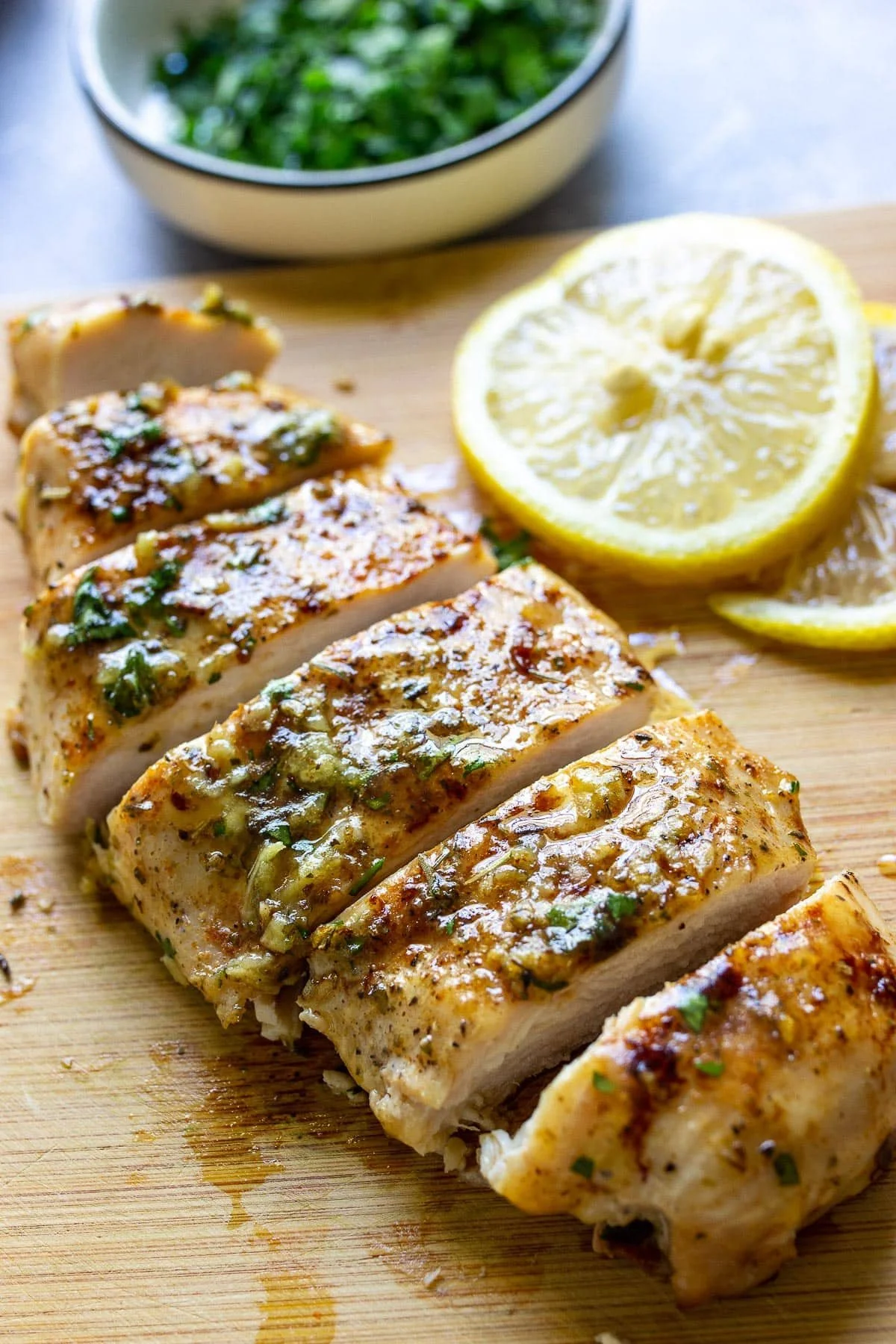 Garlic Butter Baked Chicken Breast served with herbs and spices