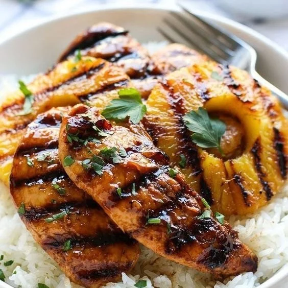 Delicious Hawaiian Chicken with pineapple and coconut rice on a plate