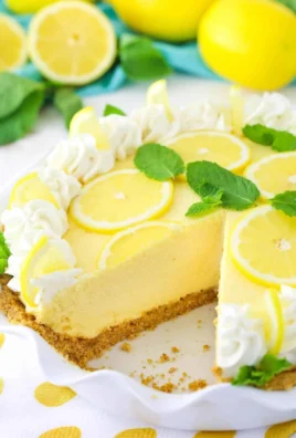 Slice of Lemon Mascarpone Cream Pie with a lemon garnish on top