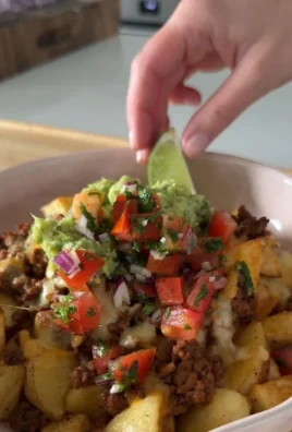 Loaded Potato Taco Bowl with toppings and crispy potatoes in a bowl