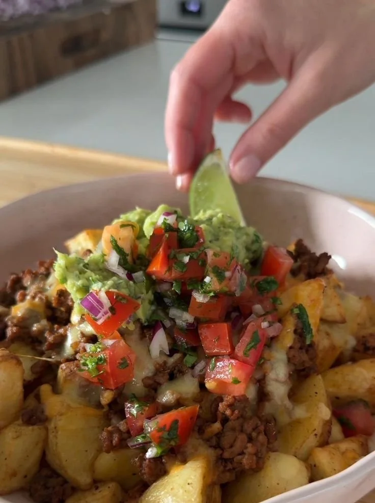 Loaded Potato Taco Bowl with toppings and crispy potatoes in a bowl