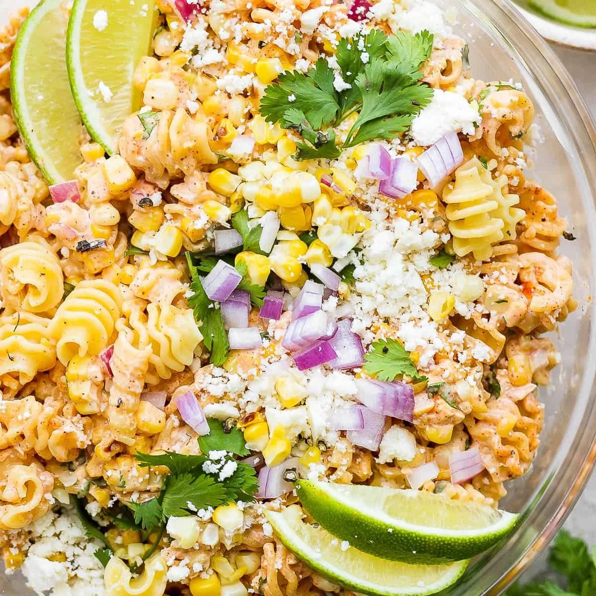 Bowl of Mexican street corn pasta salad with colorful ingredients