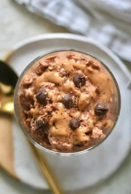 Delicious bowl of chocolate peanut butter overnight oats topped with fruits