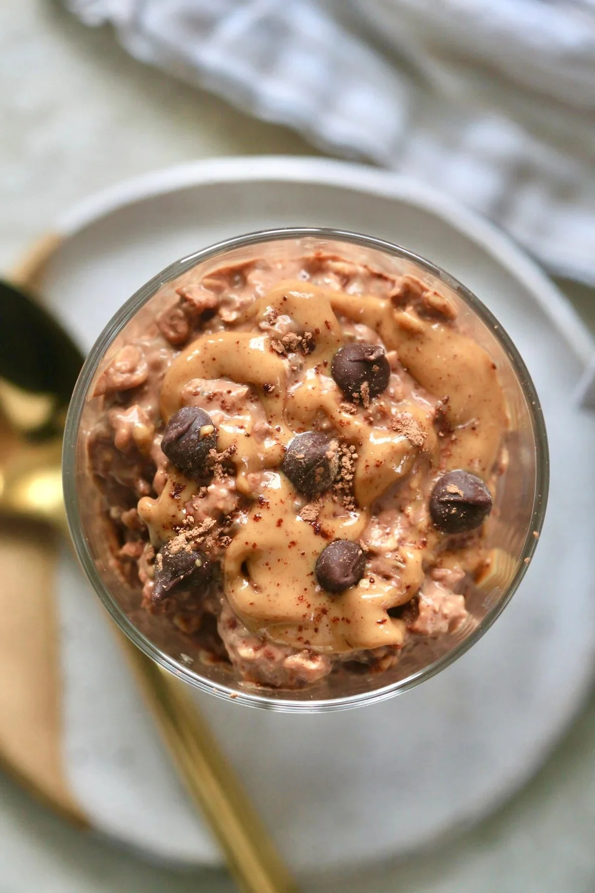 Delicious bowl of chocolate peanut butter overnight oats topped with fruits