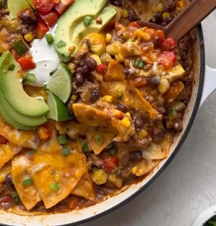 Delicious one-pan enchilada skillet filled with cheese, beans, and spices.