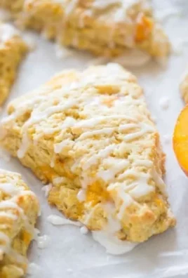 Freshly baked peach scones on a plate with a hint of glaze