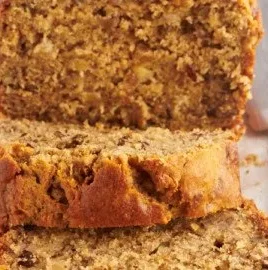 Loaf of Peanut Butter Banana Bread on a wooden cutting board