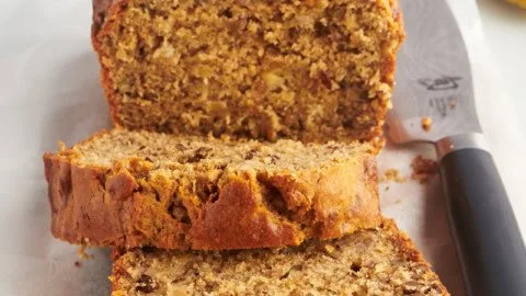 Loaf of Peanut Butter Banana Bread on a wooden cutting board