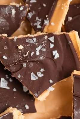 Peanut Butter Chocolate Greek Yogurt Bark topped with nuts and dark chocolate