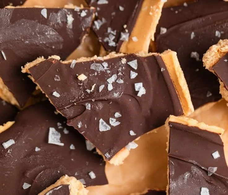 Peanut Butter Chocolate Greek Yogurt Bark topped with nuts and dark chocolate