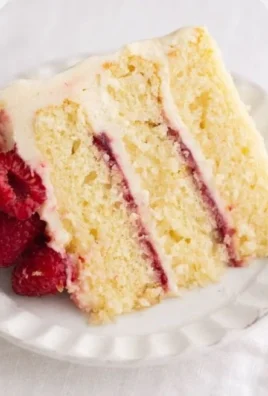 Delicious Raspberry Lemon Cake adorned with fresh raspberries and lemon slices.