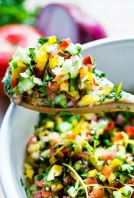 A colorful bowl of simple healthy Israeli salad with fresh vegetables.