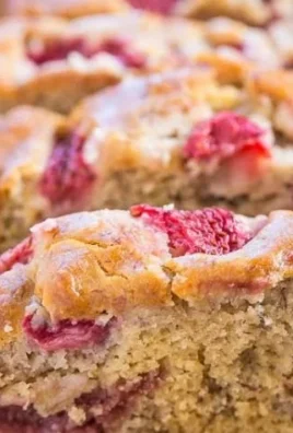 Freshly baked Strawberry Banana Bread slice on a wooden serving board.