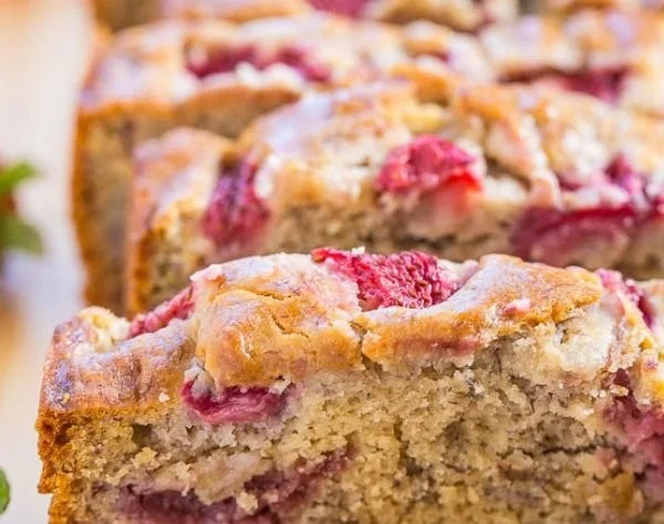 Freshly baked Strawberry Banana Bread slice on a wooden serving board.