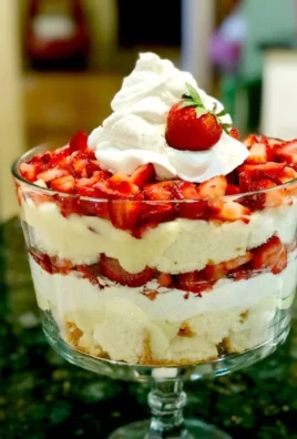 Layered Strawberry Shortcake Trifle with strawberries and whipped cream.