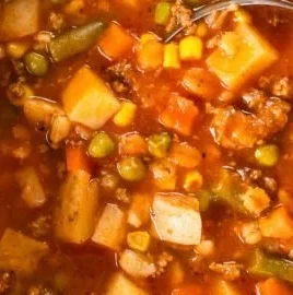 Bowl of hearty vegetable beef soup with fresh vegetables and tender beef chunks