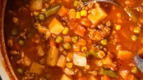 Bowl of hearty vegetable beef soup with fresh vegetables and tender beef chunks